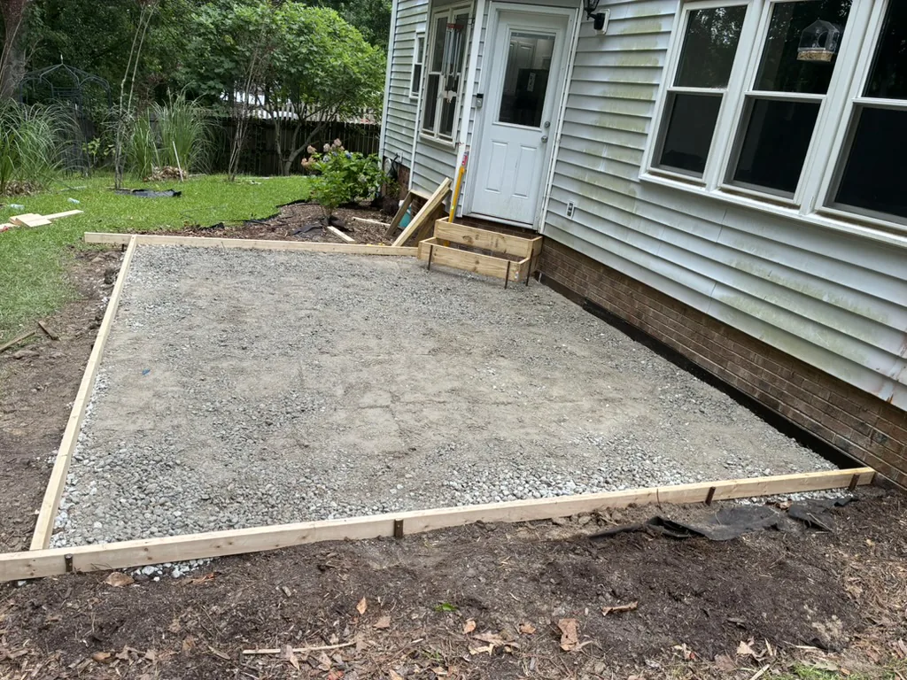Compacted aggregate base and forms prepared for a concrete patio