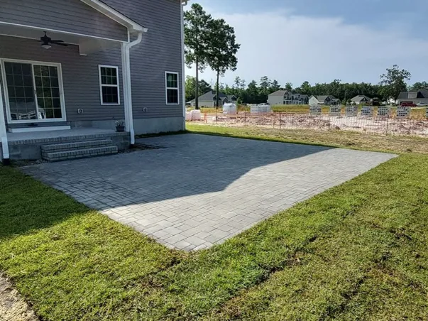 Finished paver patio behind an Eastern North Carolina home